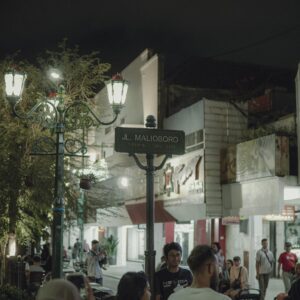Nighttime scene capturing people enjoying the vibrant atmosphere on Malioboro Street in Yogyakarta.